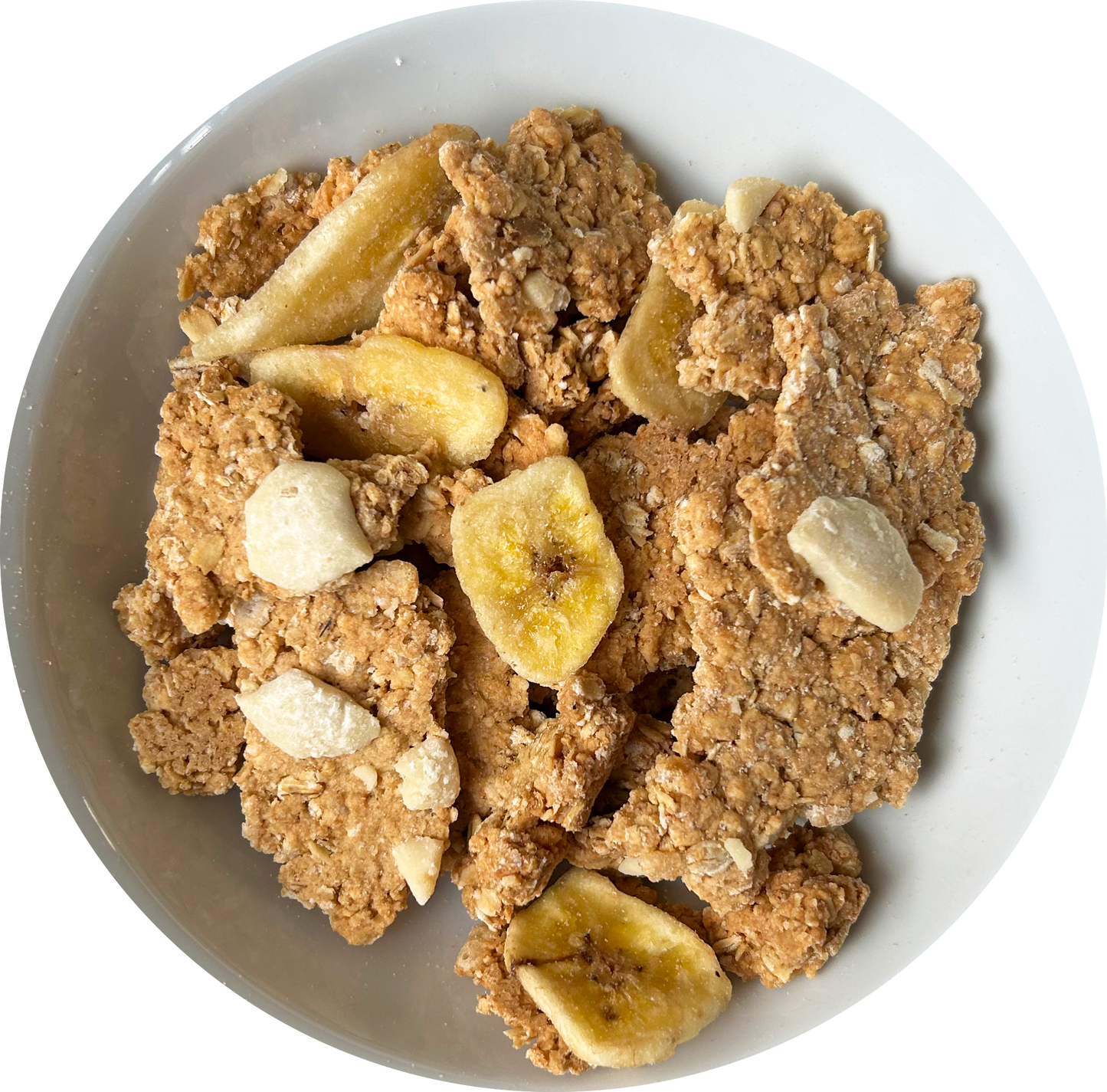 Image: A delectable bowl of Banoffee Pie granola with vegan white chocolate chips and banana slices. The granola is made up of large, chunky pieces, promising a satisfying crunch.The banana slices, arranged on top, provide a burst of fresh fruitiness that perfectly complements the granola's banoffee pie-inspired flavor. A delightful and indulgent treat for those seeking a scrumptious and plant-based breakfast or snack option