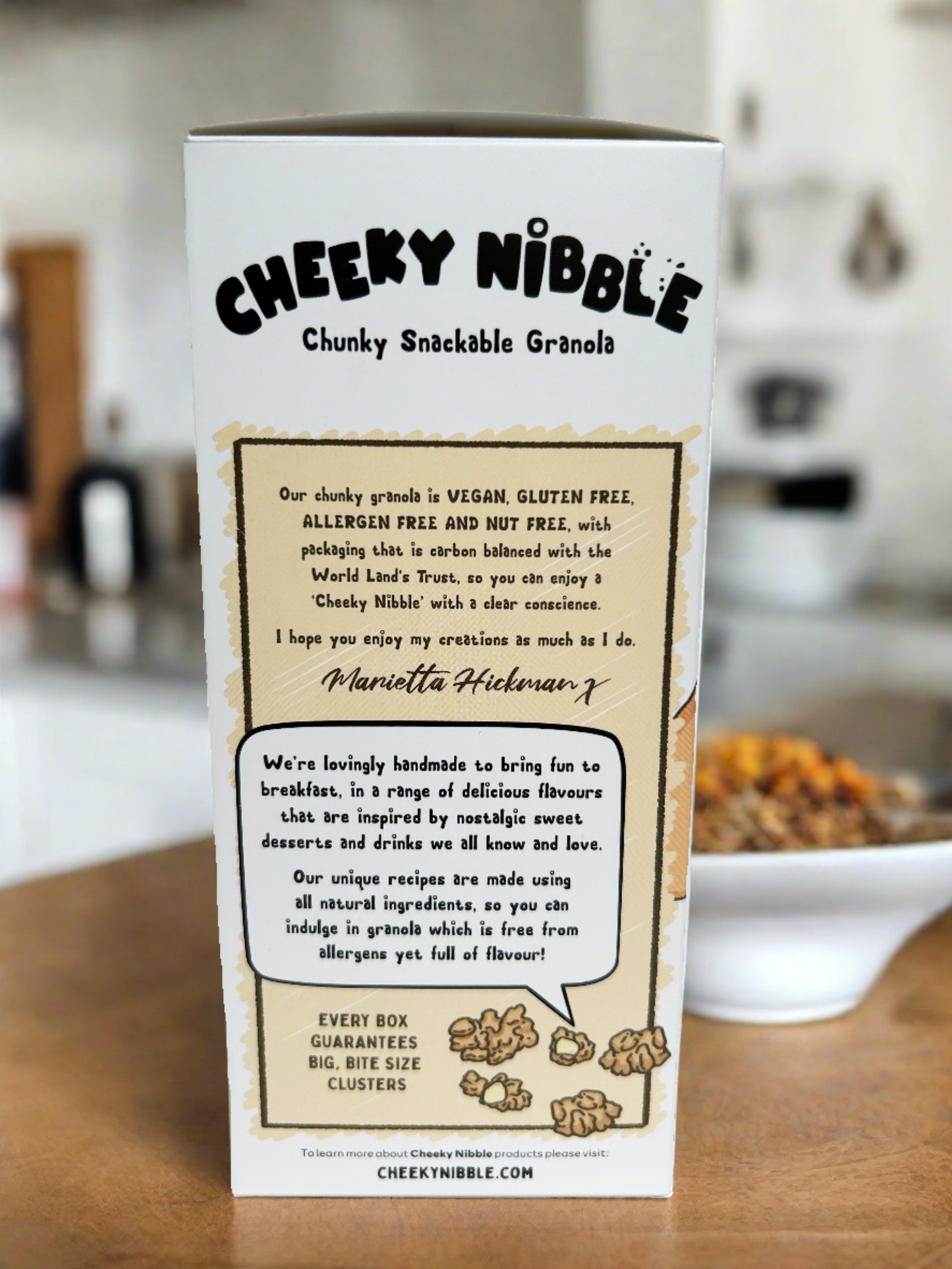 he cereal box features an image showcasing the Vanilla Latte flavored granola chunks, emphasizing their vegan and allergen-free attributes. Each chunk is depicted with detail, highlighting its robust texture and aromatic blend of vanilla and coffee flavors. The packaging prominently displays labels indicating its vegan and allergen-free status, ensuring accessibility to a wide range of dietary needs. 