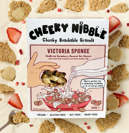  A box of Victoria Sponge-flavored chunky granola is depicted, featuring an enticing image of the granola bathed in creamy thick yogurt. The granola chunks are generously coated with white chocolate, vanilla, and strawberry flavors, creating a mouthwatering visual appeal.The packaging design may include vibrant colors and appetizing imagery, enticing consumers with promises of a delectable breakfast or snack option reminiscent of the beloved dessert.